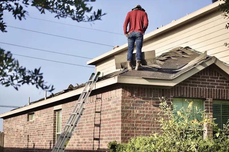 Professional roofer working on a residential roof in Bellevue Heights